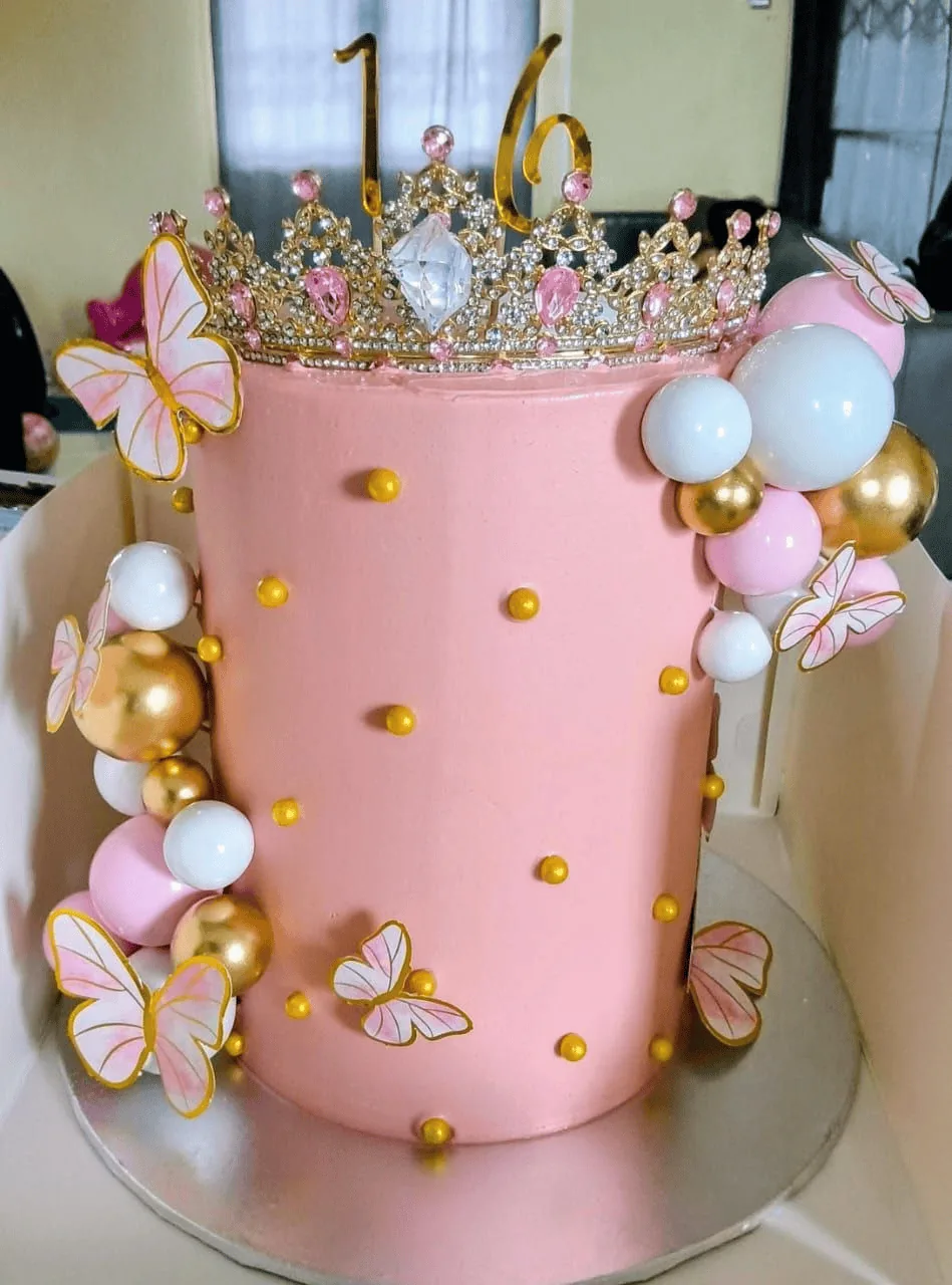 Pink floral birthday cake with butterflies and pearls